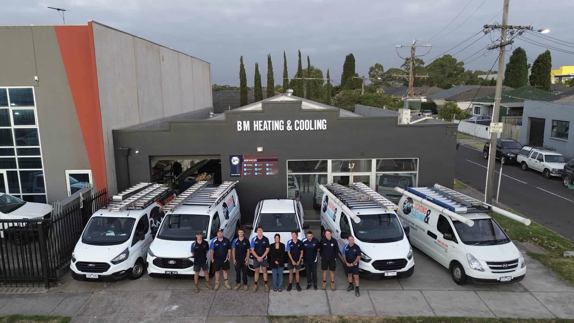 BM Heating & Cooling team and service vans